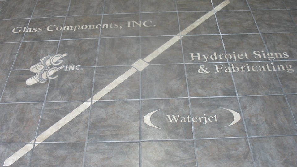 Waterjet-cut floor inlay naming Glass Components, Inc. and HydroJet Signs & Fabricating at their shared Union City, Indiana shop